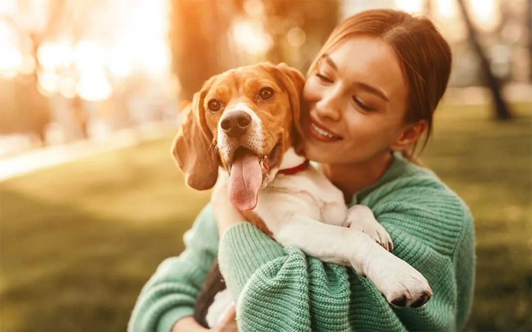 A pet parent holding her dog